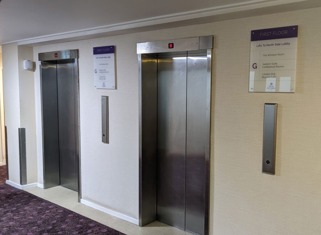 CLEAR ACRYLIC WAYFINDING PLAQUES WITH FULL COLOUR PRINT TO REVERSE ON STUDS in London