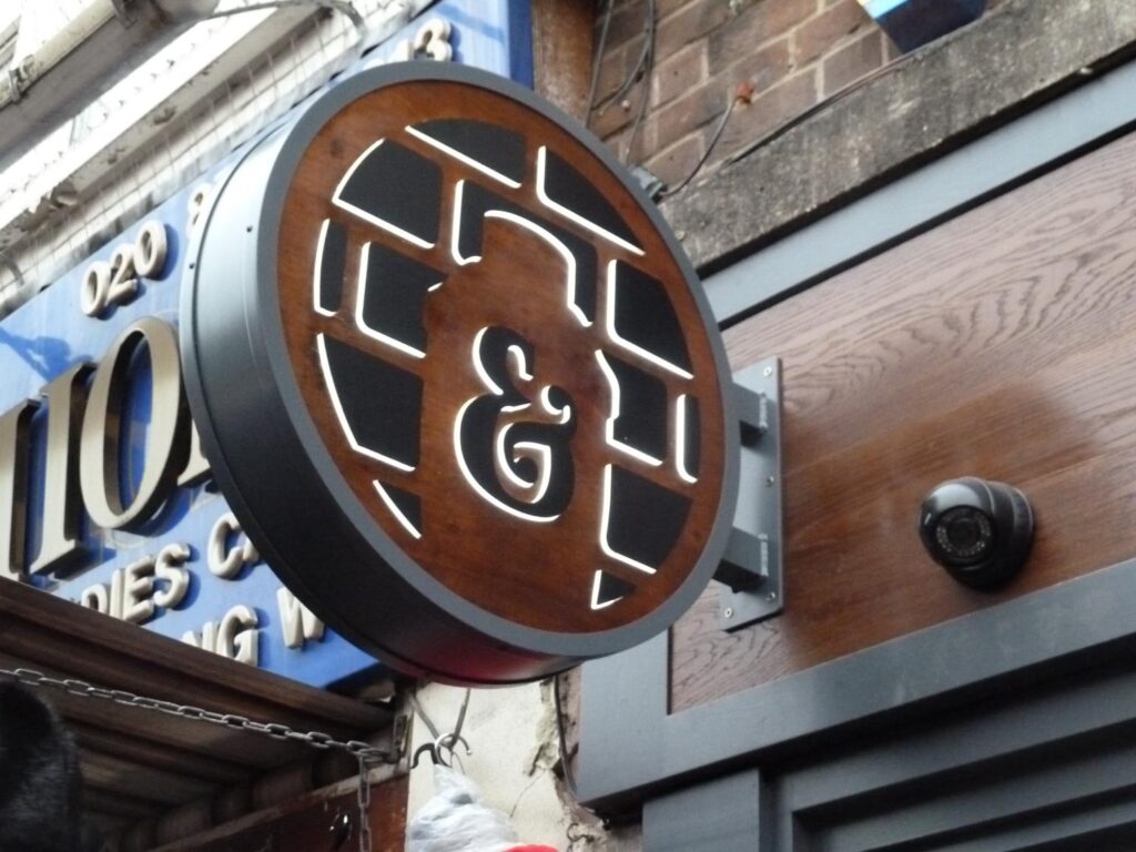 Circular Wood & Pushed-Through Acrylic Illuminated in London