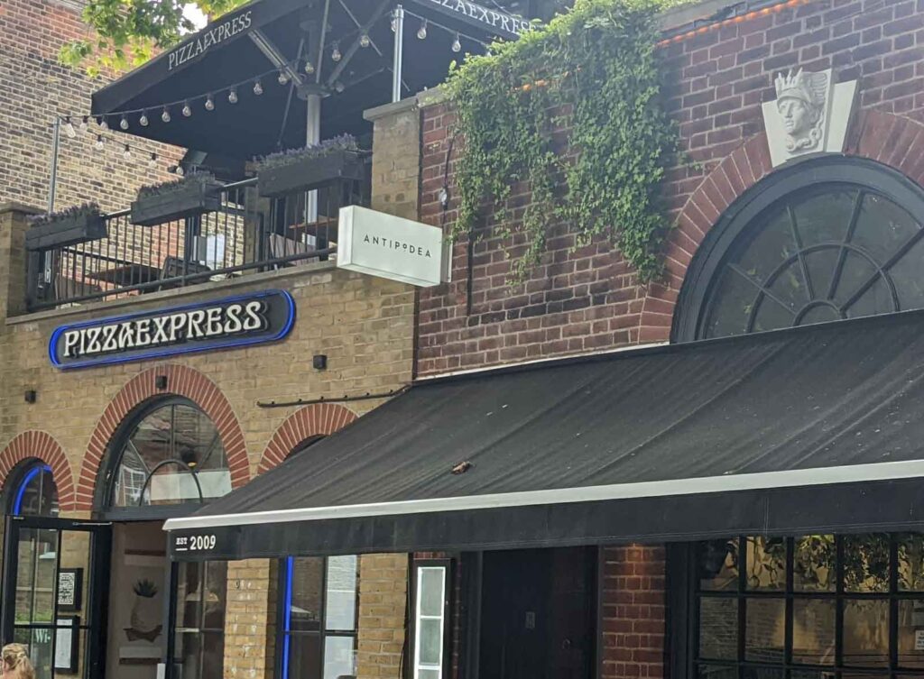 OPAL ACRYLIC LIGHTBOX PROJECTING SIGN WITH BLACK CUT VINYL LOGO in London
